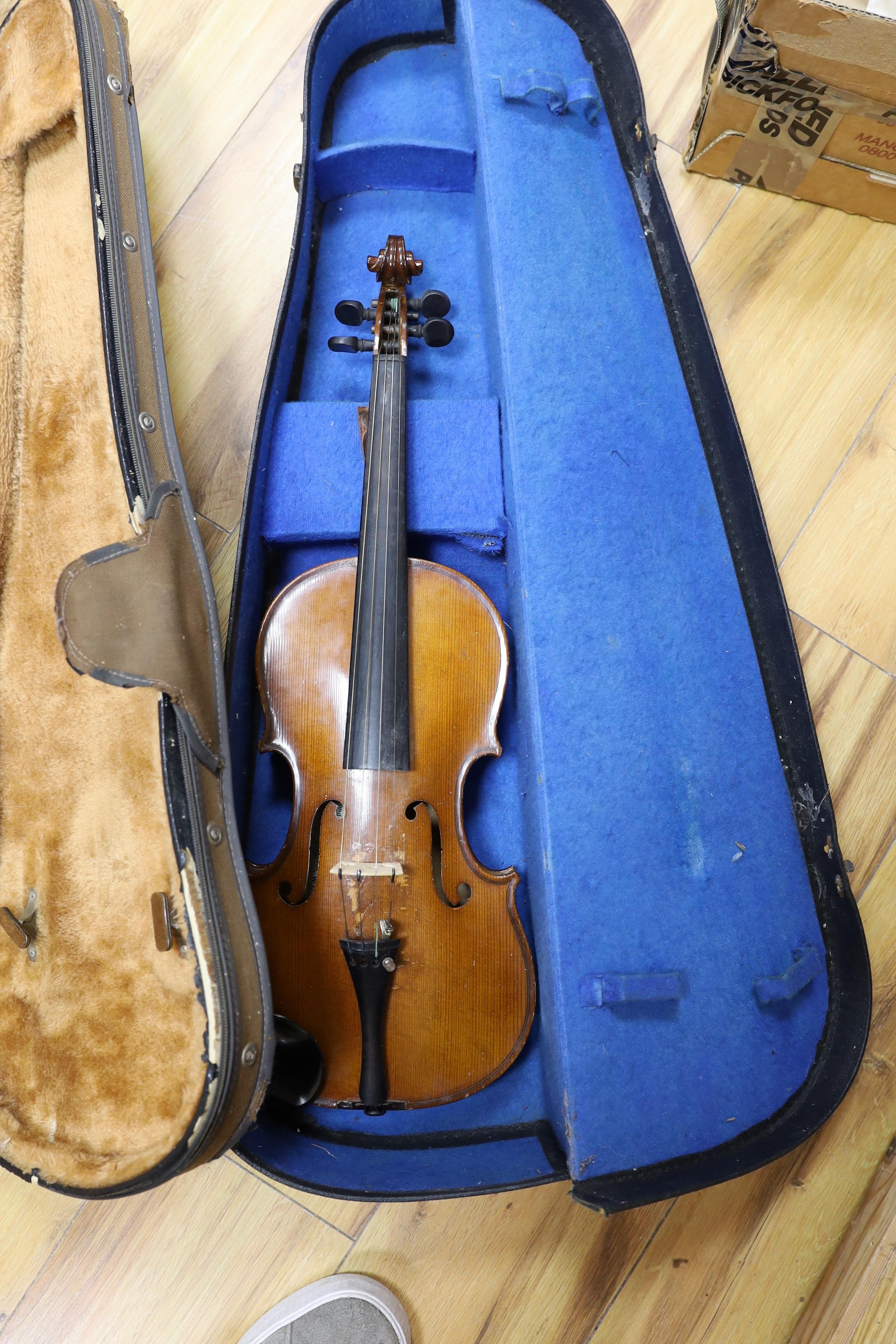 Two cased three quarter size violins, one labelled the London violin co Ltd, length of back 33.5 cm together with a wooden violin case